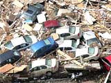 Gulfport: Timber and cars put together after hurricane
        "Katrina".