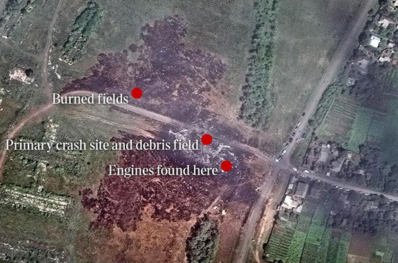 The
                          fireplace near Grabovo with the heap of debris
                          and two little engines allegedly from a
                          Boeing777 from flight MH17 of July 17, 2014