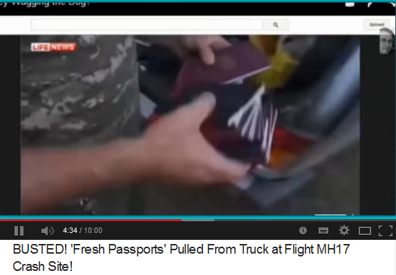 Brand-new
                faked passports for the original passengers of flight
                MH17 of July 17, 2014 - shown by a police commander