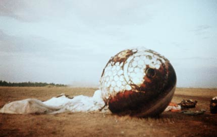 Gagarin's alleged landing capsule on a
                          green meadow
