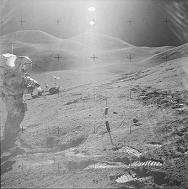 Apollo 15 in the moon hall: Irwin with two
                    Suns and a Rover in the background.