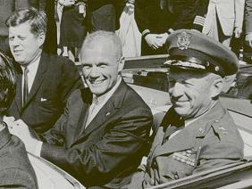 Kennedy with Glenn in a cabriolet on
                              triumph ceremony