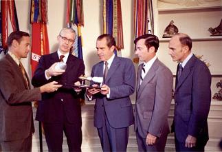 Nixon decorating himself with Apollo
                              16 astronauts, together with Dr.
                              Fletcher.