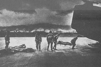 "USA": Dead Vietnam war
                              victims are loaded by marines.
