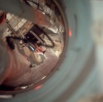 Apollo 11 photo no. AS11-36-5385:
                        "Astronaut" Neil Armstrong floats in
                        the tunnel connecting the lunar module (LM) and
                        the command module (CM), using the TV to
                        document Buzz doing a LM inspection. This photo
                        was taken by Mike Collins. So claims NASA.