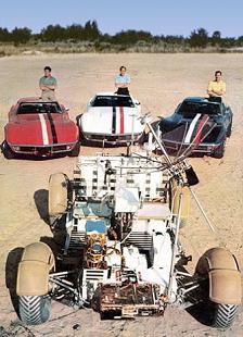 Training for Apollo 15:
"Moon car" in the foreground, in the
background are staying the three astronauts with
their Corvets. Training for Apollo 15: "Moon
car" in the foreground, in the background
are staying the three astronauts with their
Corvets.