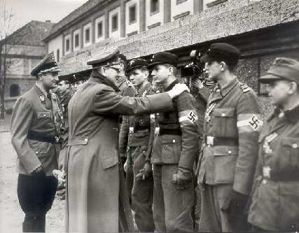 Hitler am 20.3.1945, Auszeichnung
von Volkssturmkämpfern mit dem Eisernen Kreuz, mit klarem
Buckel, und die linke Hand sieht man nicht. Hitler am
20.3.1945, Auszeichnung von Volkssturmkämpfern mit dem
Eisernen Kreuz, mit klarem Buckel, und die linke Hand
sieht man nicht.