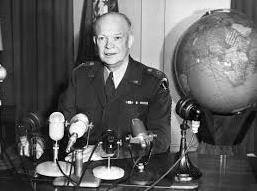 Mass murderer Eisenhower with
"U.S." flag and with a globe Mass murderer Eisenhower with
"U.S." flag and with a globe