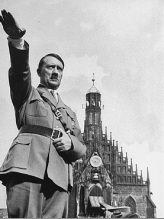 Adolf Hitler with Hitler salute
                              before Church of Our Lady (Frauenkirche)
                              at Nuremberg, September 1934. His left
                              hand is hanging at the belt buckle so
                              trembling of his arm cannot be seen.