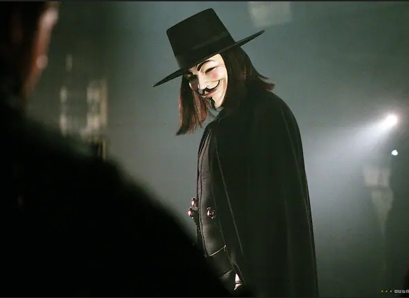 Photo text 7: MASK WITH NOSE OPENINGS: "V for
Vendetta" with Natalie Portman: "V" wears a
mask which is a copy of the face of Guy Fawkes. Photo text 7: MASK WITH NOSE OPENINGS: "V for
Vendetta" with Natalie Portman: "V" wears a
mask which is a copy of the face of Guy Fawkes.