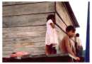 Orinoco River delta, native children at a
                      wooden house